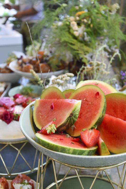 a plate of watermelon and strawberries on a table at Hotel Villa Rosa Riviera in Rimini