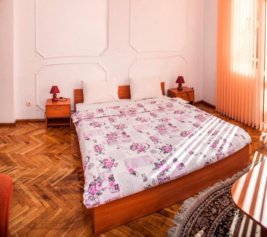 A bed or beds in a room at Central GuestHouse Five Corners