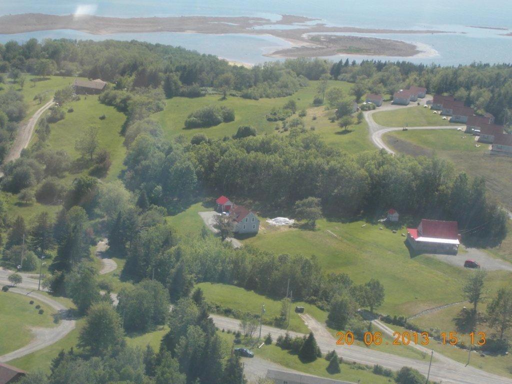 an aerial view of a house on a green field at Chisholms of Troy Coastal Cottages in Port Hawkesbury