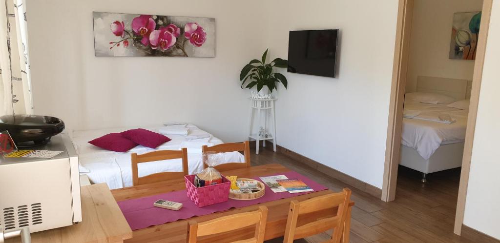a room with a table and a dining room with a tableablish at Apartments Maraž in Portorož