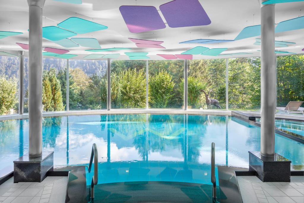 a swimming pool with a view of the mountains at Hotel Waldegg - Adults only in Engelberg