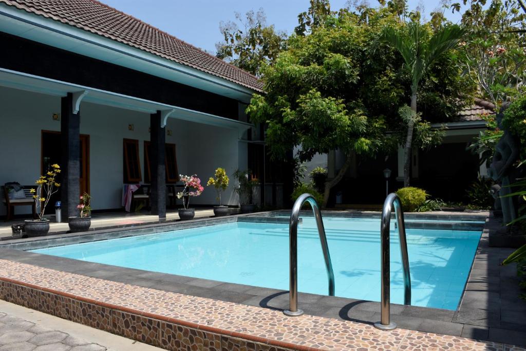 a swimming pool in front of a house at Villa Ditya - Luxury villa near Yogyakarta in Klaten
