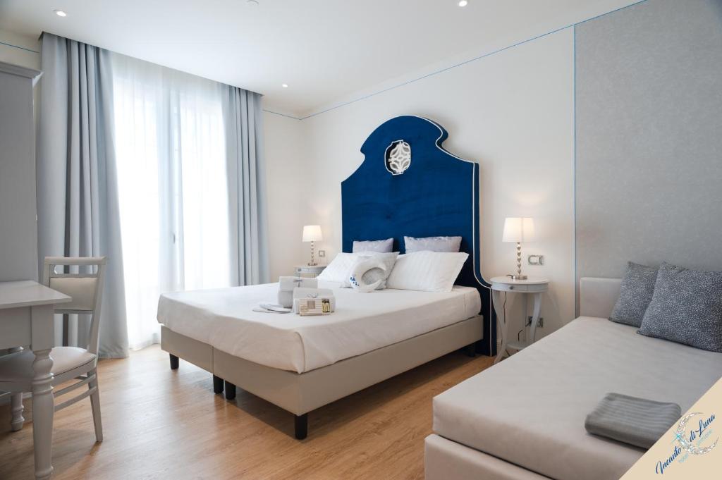 a hotel room with a bed and a couch at Incanto di Luna Hotel in Sirmione