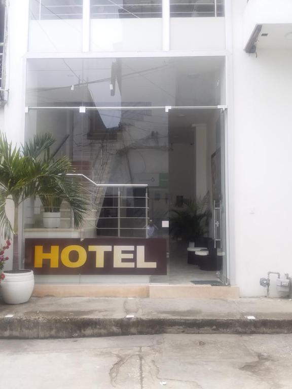 a hotel sign in the window of a building at Perla De La Sabana in Corozal