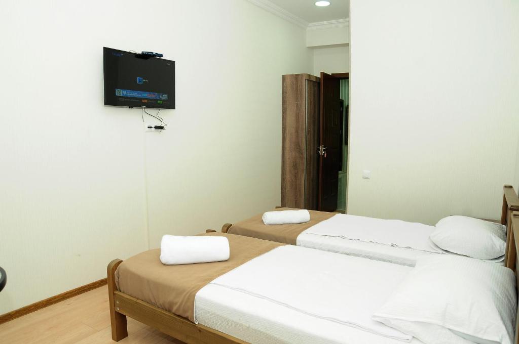 Postel nebo postele na pokoji v ubytování Family Hotel Chino
