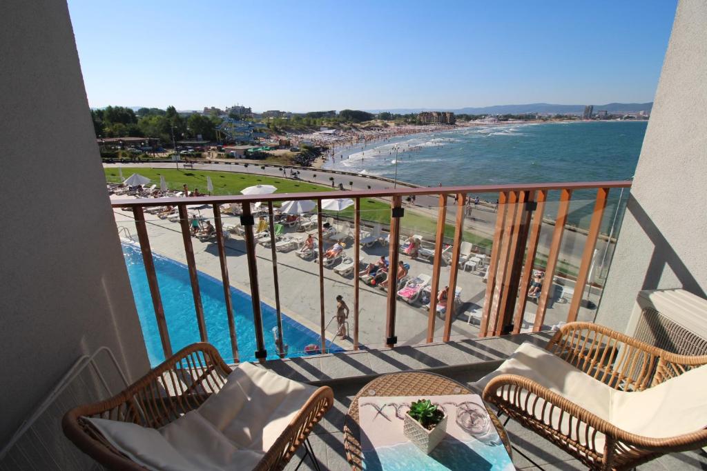 a balcony with a view of the beach and the ocean at PARADISO 308-309 Private Studios Nessebar in Nesebar
