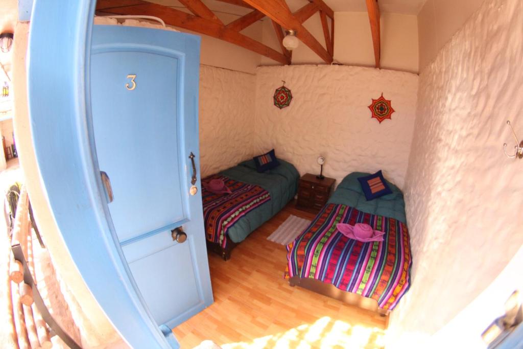 Postel nebo postele na pokoji v ubytování Hostal Mamatierra