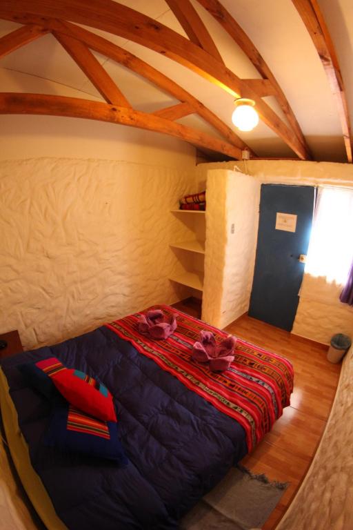 Postel nebo postele na pokoji v ubytování Hostal Mamatierra