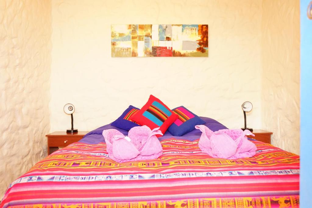 Postel nebo postele na pokoji v ubytování Hostal Mamatierra