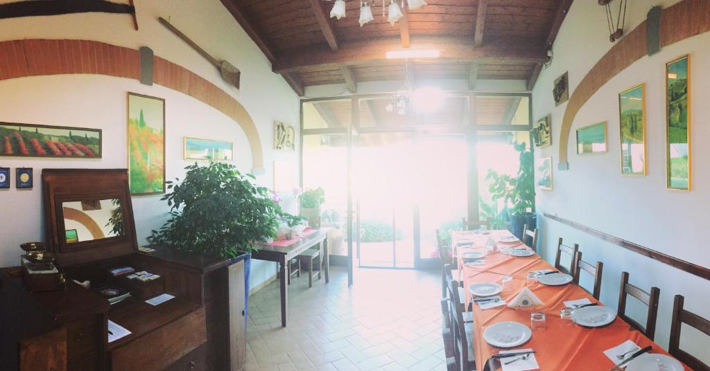 jadalnia z długim stołem w restauracji w obiekcie Agriturismo "Le Rondinelle" w mieście Valiano