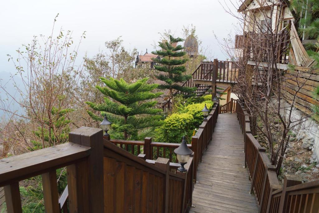 a wooden walkway leading up to a building at Spring Ground Resort in Ren&#39;ai