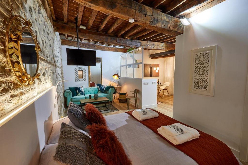 1 dormitorio con 1 cama grande y sala de estar en Lofts amantes de Toledo -LOFT COBERTIZO, en Toledo