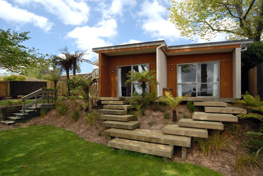 a small house with stairs leading up to it at B&B@The Redwoods in Rotorua