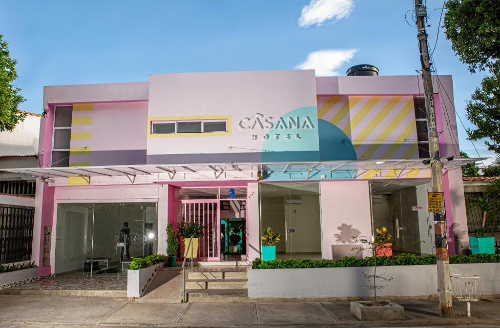 um edifício cor-de-rosa com um cartaz. em Casana Hotel em Cúcuta