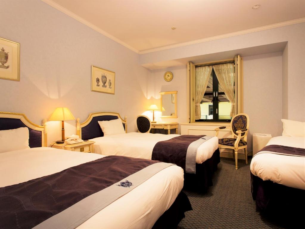 Postel nebo postele na pokoji v ubytování Hotel Monterey Osaka