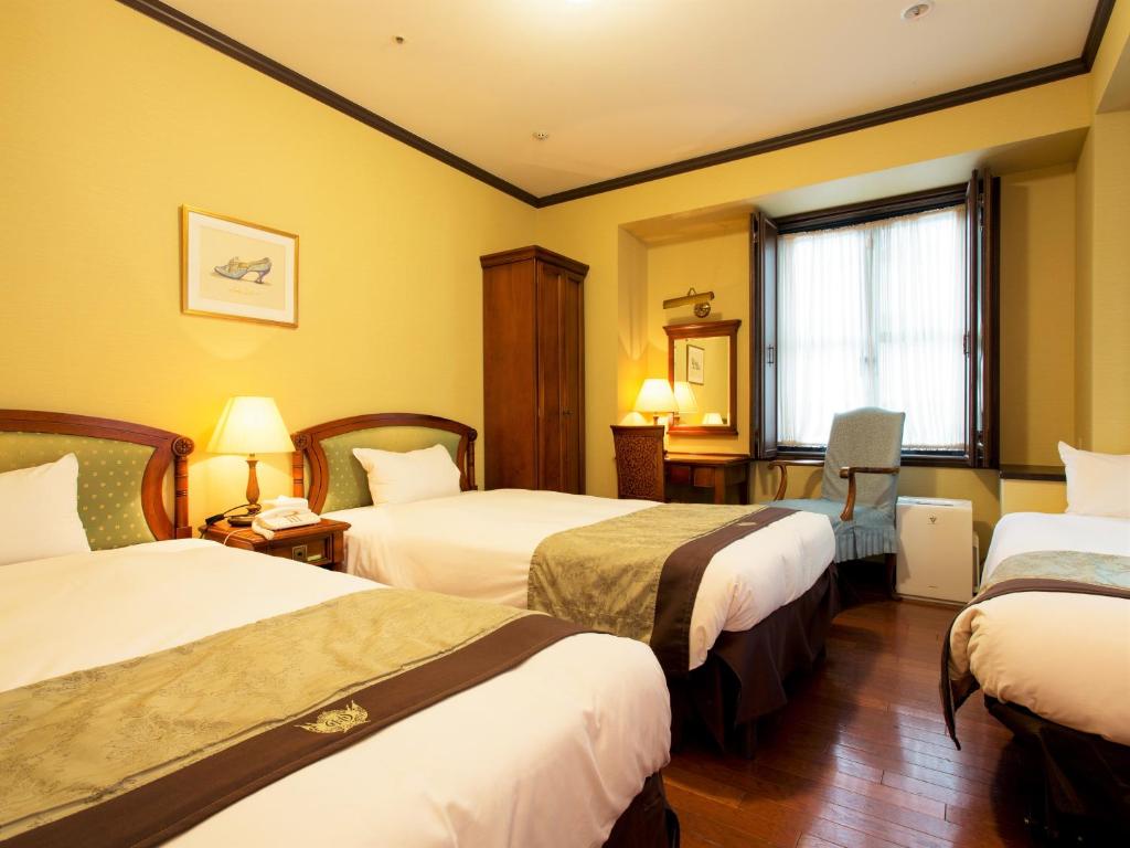 Postel nebo postele na pokoji v ubytování Hotel Monterey Osaka