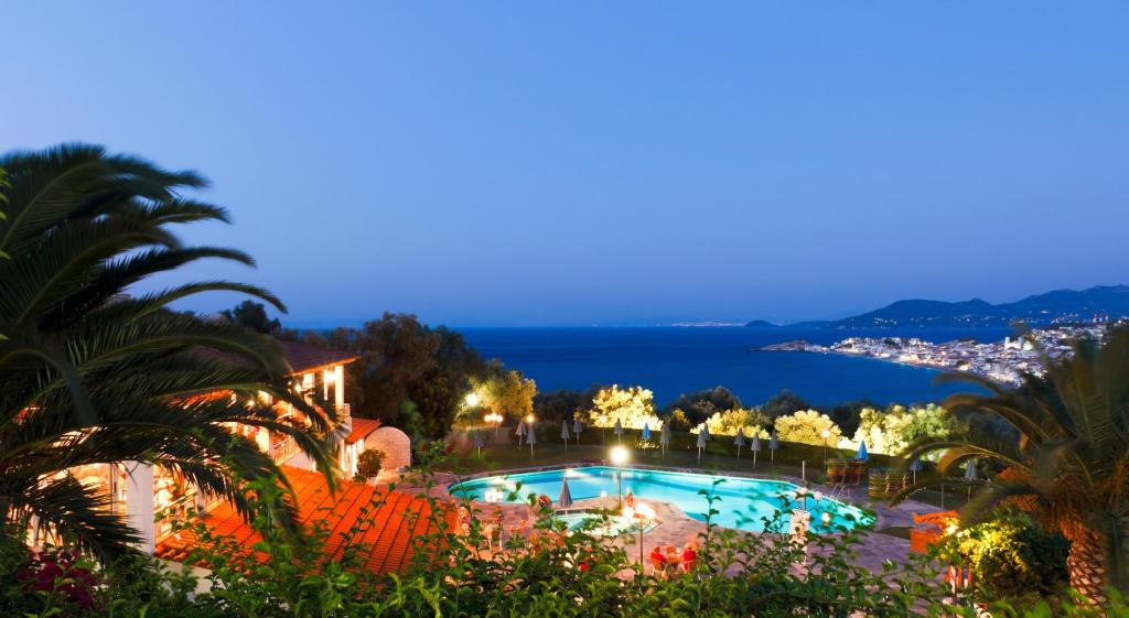 a view of a swimming pool at night at Arion Hotel in Kokkari