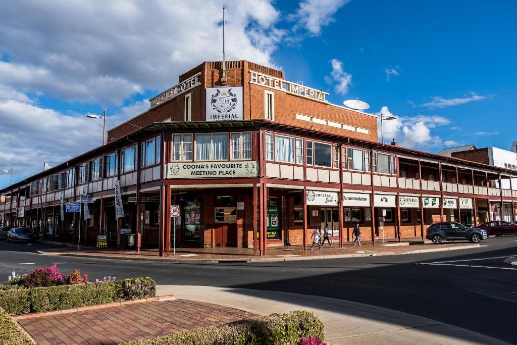 a large building with a clock on the top of it at Imperial Hotel Coonabarabran in Coonabarabran