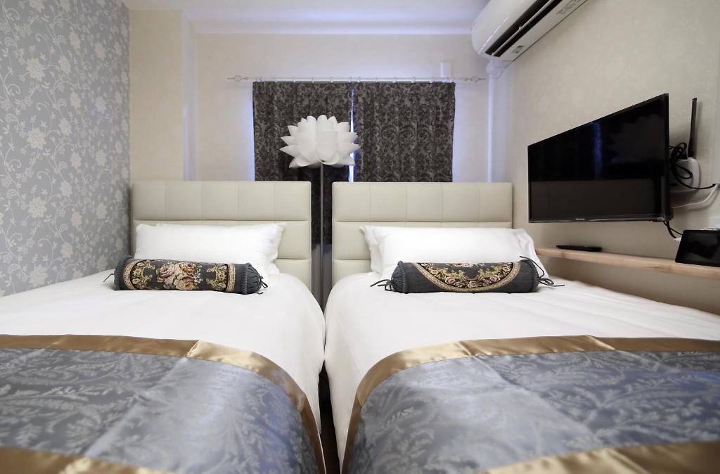 Postel nebo postele na pokoji v ubytování SHINJUKU GLOBAL HOTEL