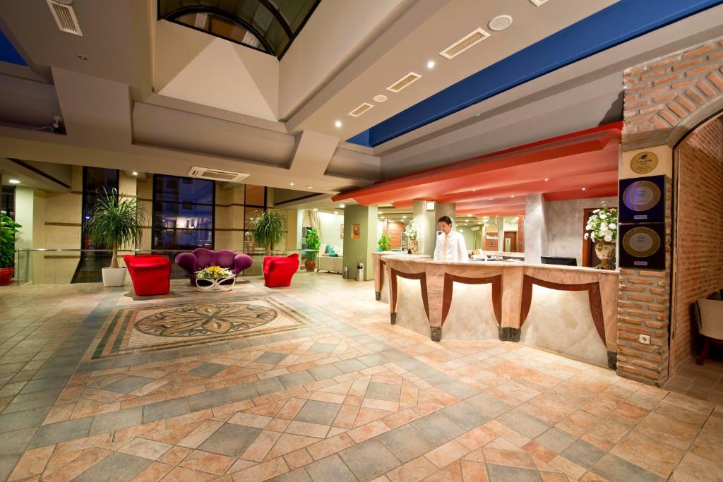 a lobby of a hotel with a table and chairs at Limak Arcadia Sport Resort Belek in Belek