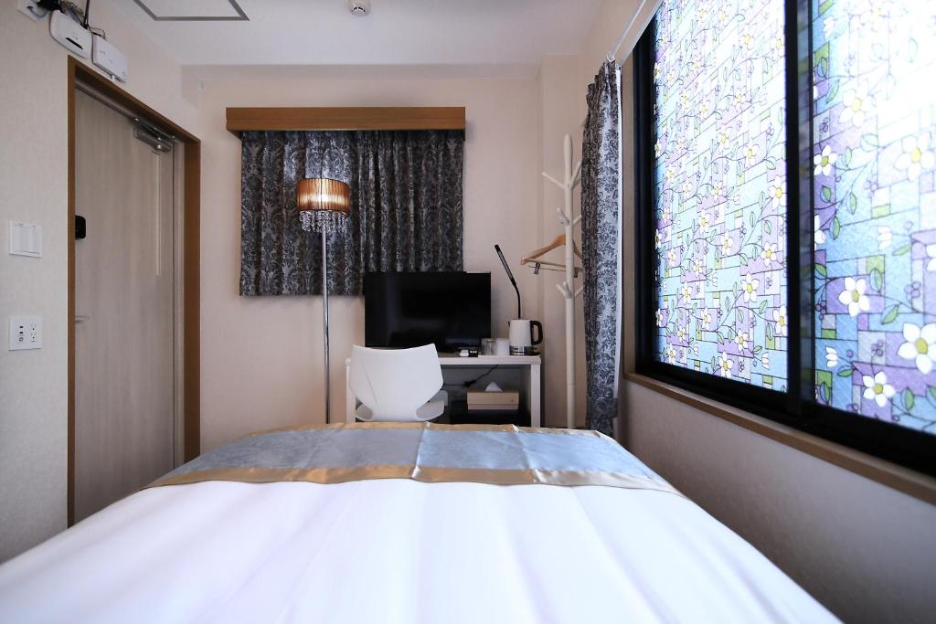 Postel nebo postele na pokoji v ubytování SHINJUKU GLOBAL HOTEL