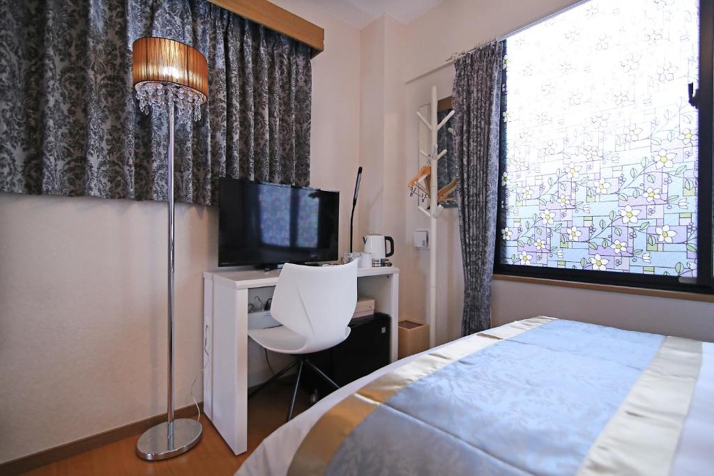 Postel nebo postele na pokoji v ubytování SHINJUKU GLOBAL HOTEL