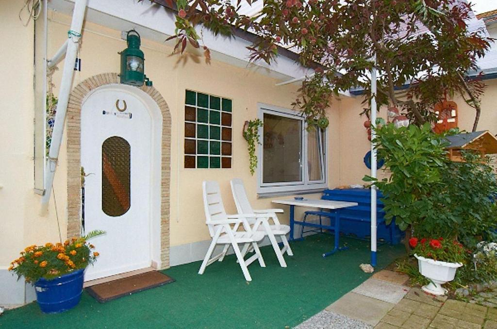 ein Haus mit einem Tisch und Stühlen auf einer Terrasse in der Unterkunft Ferienwohnung für 4 Personen in Sassnitz in Sassnitz