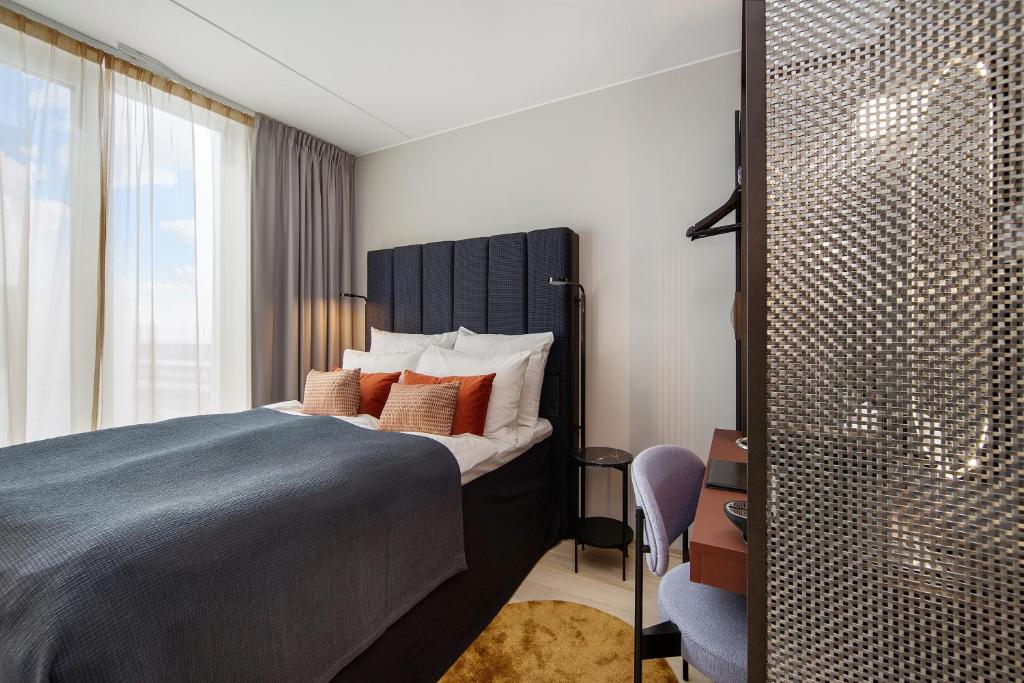 a bedroom with a large bed and a window at Clarion Hotel Oslo in Oslo