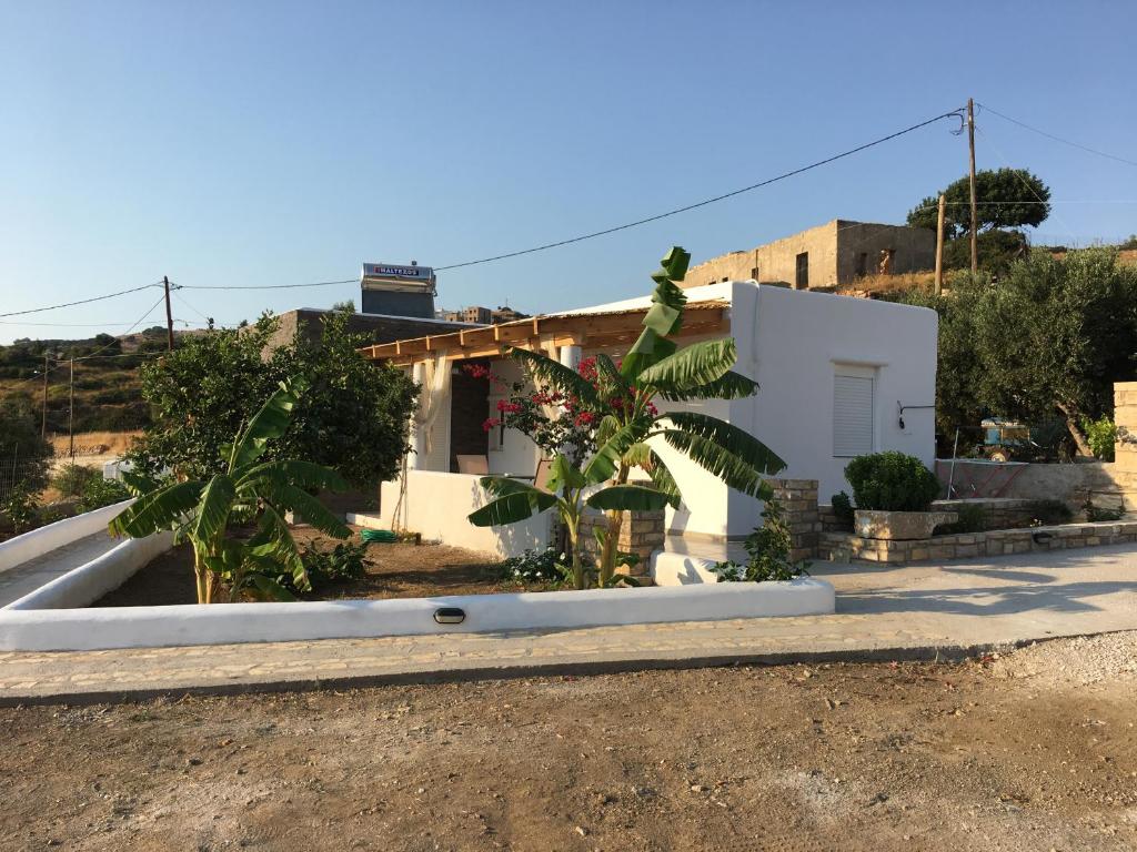 a white house with trees in front of it at Villakia Katerina in Lipsoi