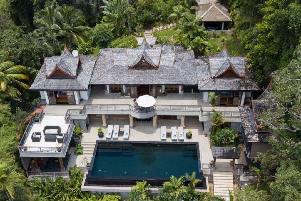 an aerial view of a house with a swimming pool at Luxury 5 bedrooms Villa with Seaview Infinity Pool overlooking Surin Beach in Surin Beach