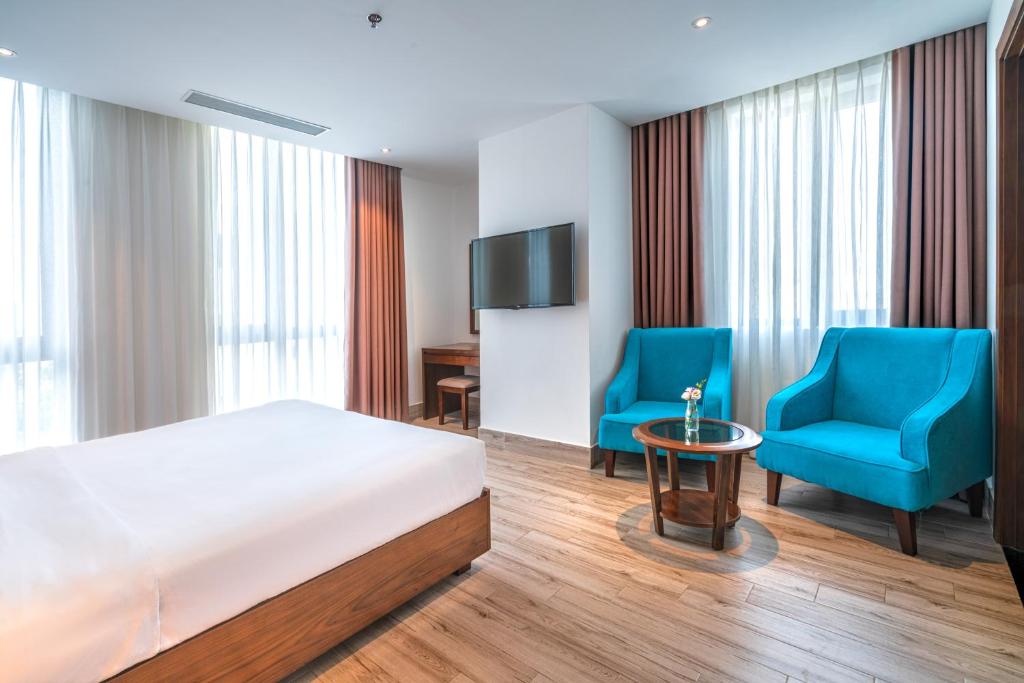 Postel nebo postele na pokoji v ubytování Greenery Hotel