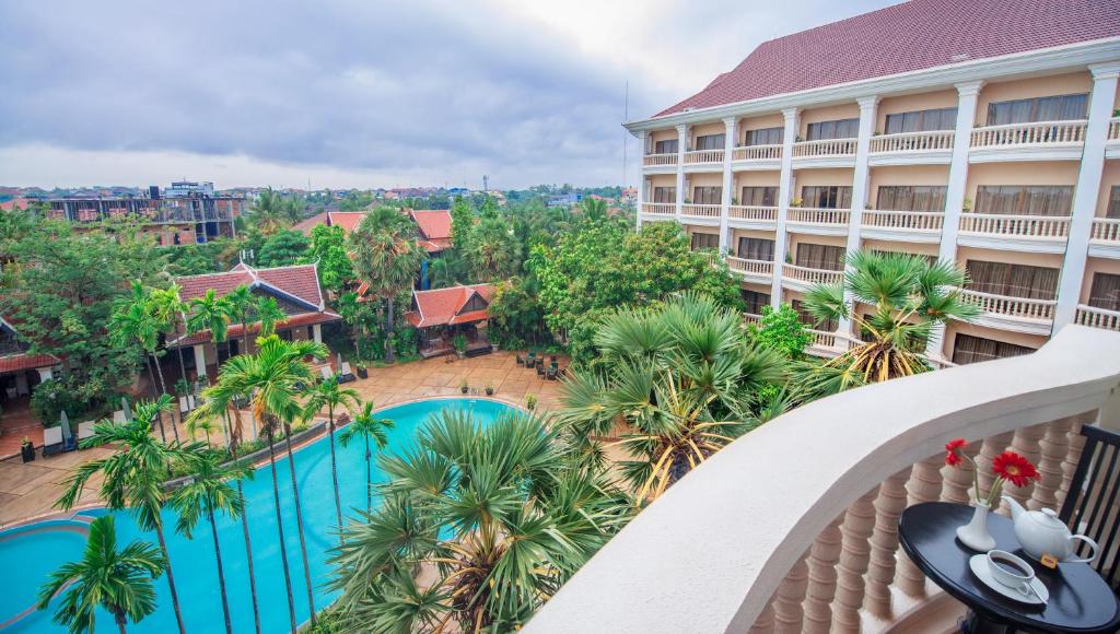 an aerial view of a hotel with a pool and palm trees at Borei Angkor Resort & Spa in Siem Reap