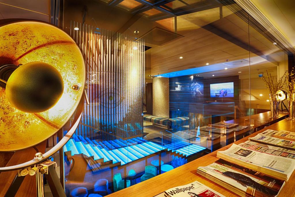 a room with a table and a musical instrument at Hotel Klaus K in Helsinki