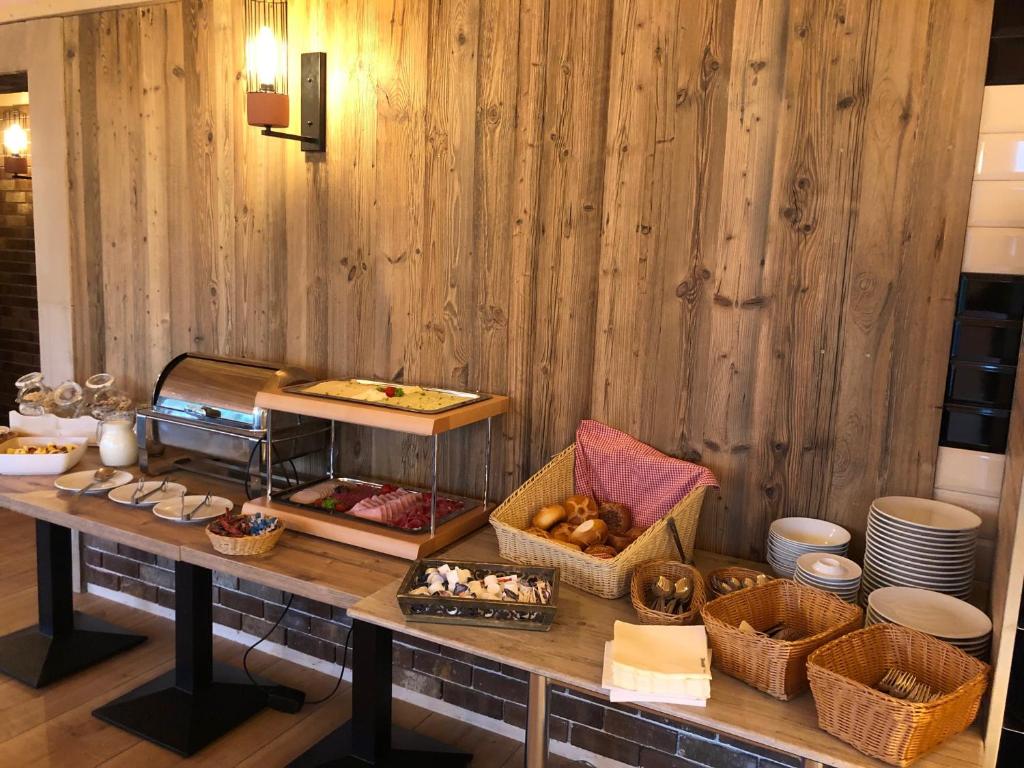 a buffet with bread and pastries on a table at Carolinger Hüttendorf in Weyer