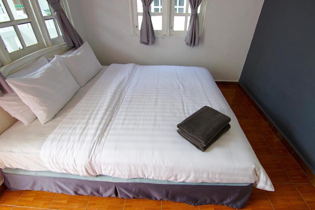 Postel nebo postele na pokoji v ubytování Vagary Pangkor
