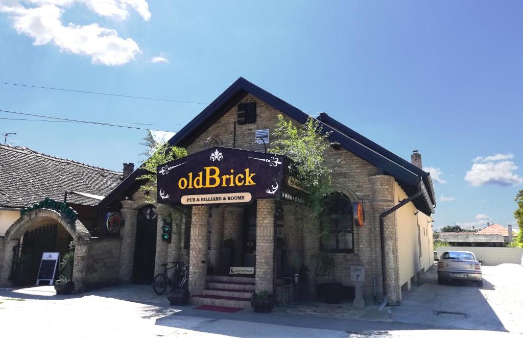 an old brick building with a sign that reads old brick at OldBrick PUB in Sombor