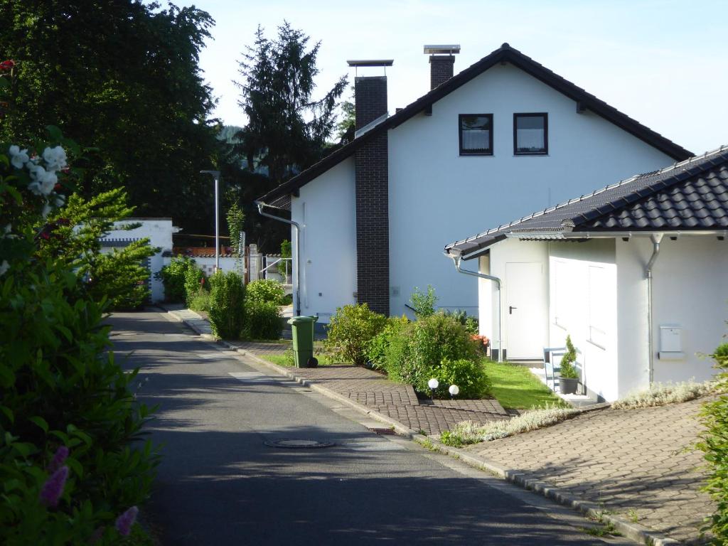 a white house next to a street at Ferienwohnung Dora 1 in Michelstadt