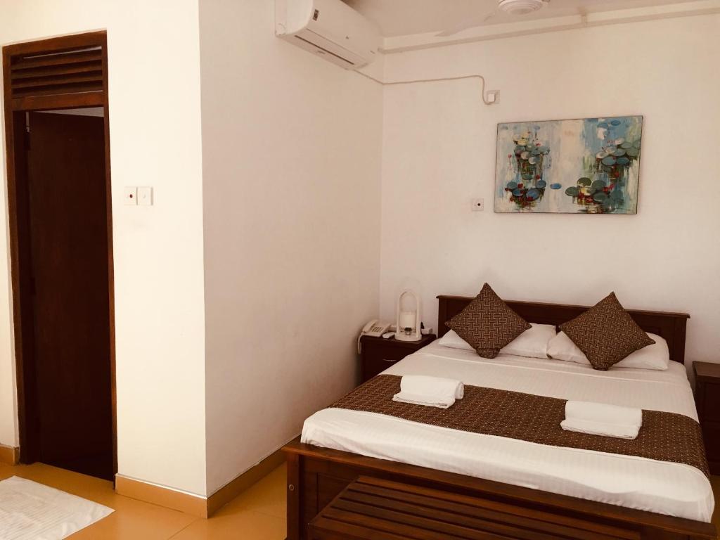 Postel nebo postele na pokoji v ubytování Sarvodaya Samma Vaasa Residence