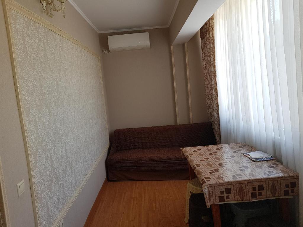 a small room with a couch and a table at Apartment on Lakoba 60 in Novy Afon