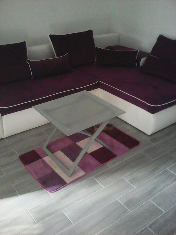 a living room with a couch and a coffee table at Apartmani Pavković in Stari Mikanovci