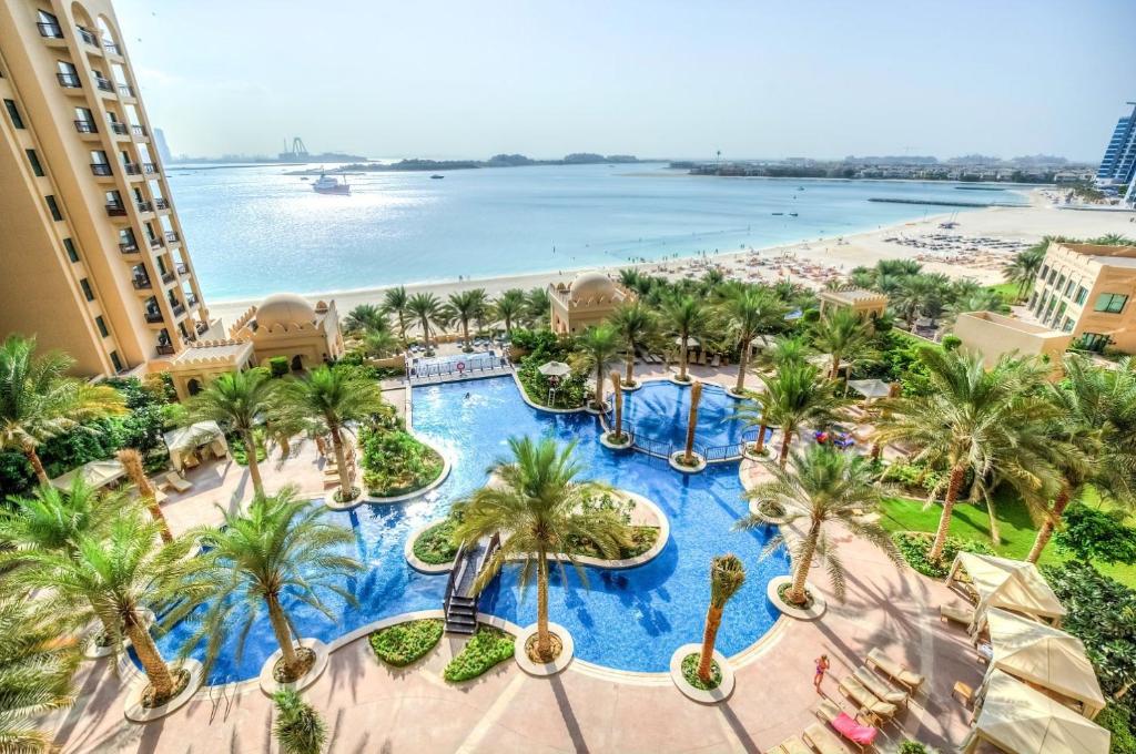 an aerial view of a resort with palm trees and a beach at South & North Residence Palm Jumeirah in Dubai