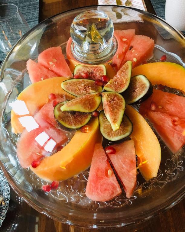 a glass plate filled with fruit on a table at LES CHAMBRES D&#39;HOTES DU PALAIS in Douai