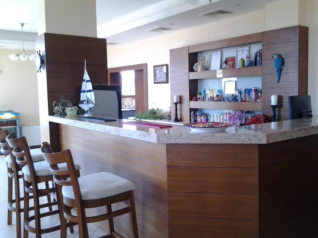 a bar with a counter with chairs in a room at Guest House Golden Flake 4km from Bolata beach in Bŭlgarevo