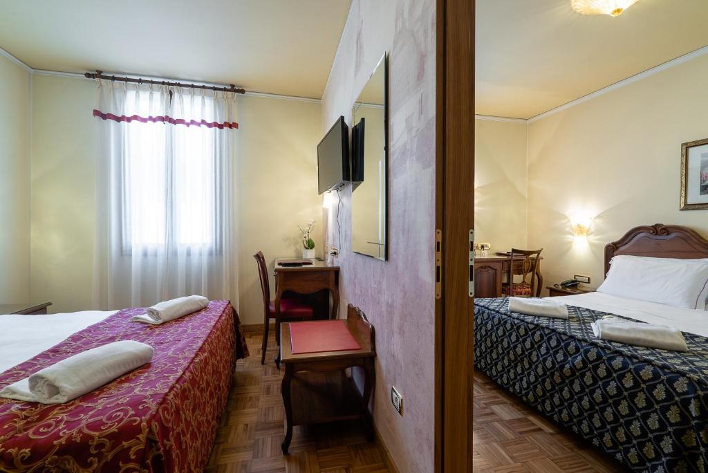 Postel nebo postele na pokoji v ubytování Hotel Spessotto