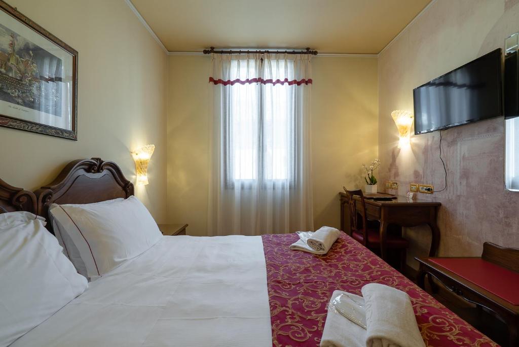 Postel nebo postele na pokoji v ubytování Hotel Spessotto