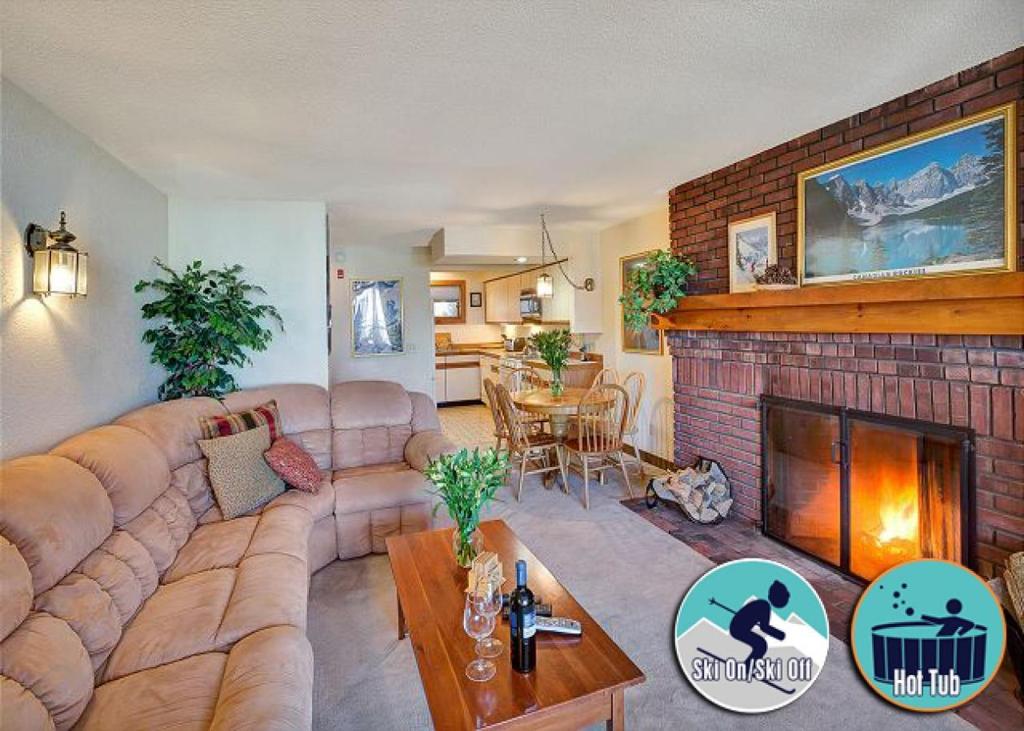 a living room with a couch and a fireplace at Ski on ski off, conveniently located, 2 bedroom condo with beautiful views, access to indoor pool Sunrise B3 in Killington