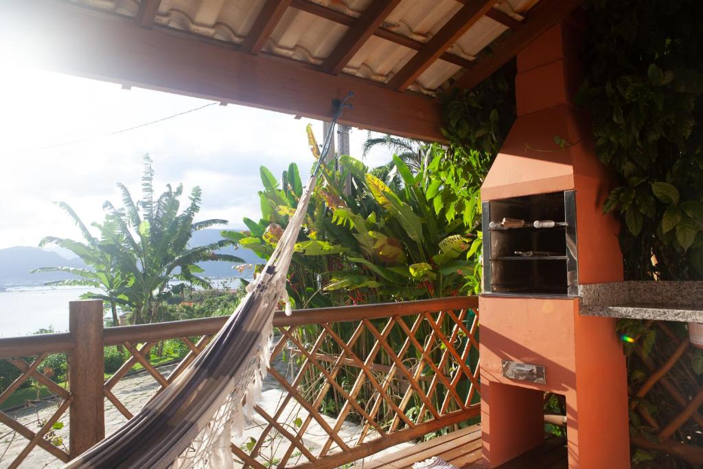 una hamaca fuera de una casa con vistas al océano en Casas em Ilhabela com Linda vista, em Vila Paulino, casas Colibri e Tucano, praia Itaguaçu, en Ilhabela