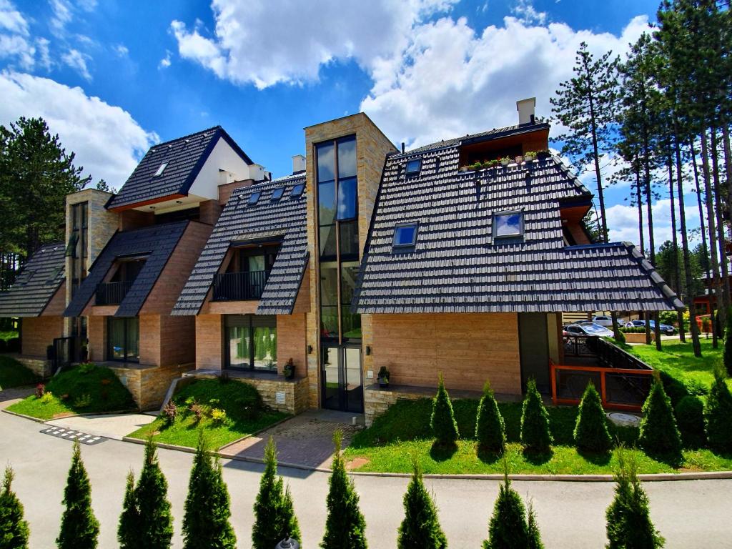 a house with solar panels on its roof at Apartments Pino D'oro in Zlatibor