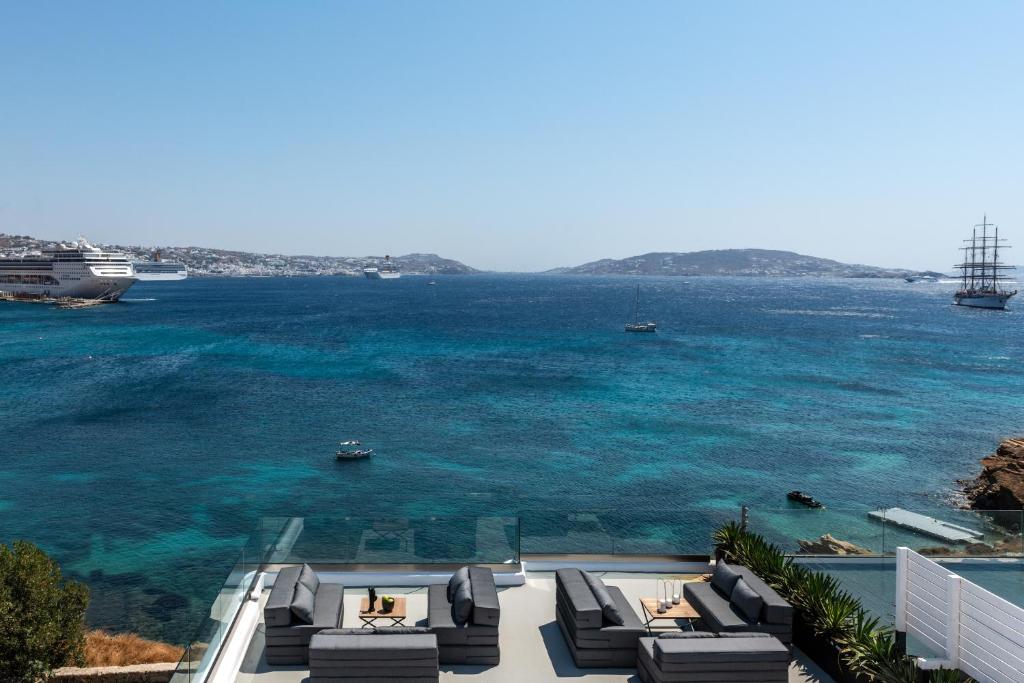 a view of the ocean with a cruise ship in the water at Obsession Mykonos in Agios Stefanos
