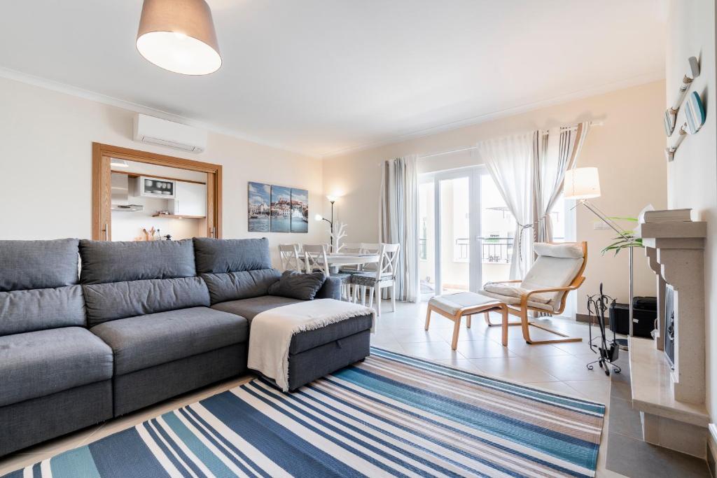 a living room with a gray couch and a table at Cabanas, Tavira, T3, O Pomar condominium in Cabanas de Tavira